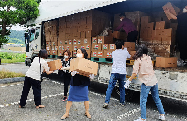 지난 6일 서산종합운동장에서 직원들이 ㈜청정에서 기탁한 마스크를 옮기는 모습